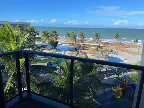 a view of the beach from the balcony of a resort at HOTEL PIRÂMIDE NATAL in Natal