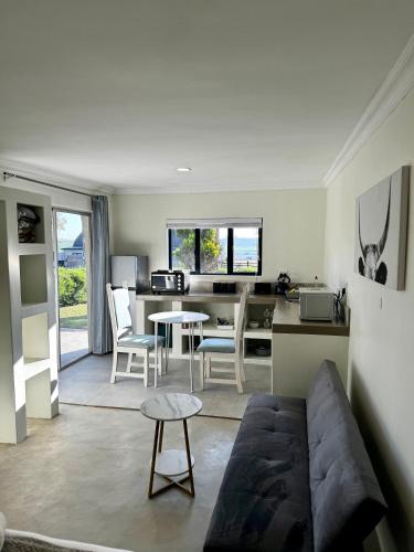 a living room with a couch and a table at Rosetta Fields Country Lodge in Rosetta