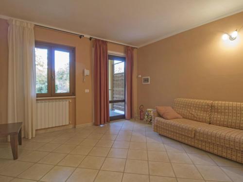 a living room with a couch and a table at Apartment Thermae Apartment 16b by Interhome in Sorano