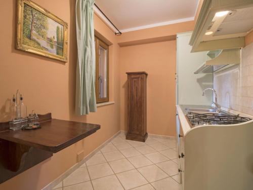 a kitchen with a counter and a stove top oven at Apartment Thermae Apartment 16b by Interhome in Sorano