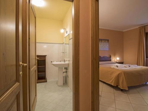 a bedroom with a bed and a sink in a room at Apartment Thermae Apartment 16b by Interhome in Sorano