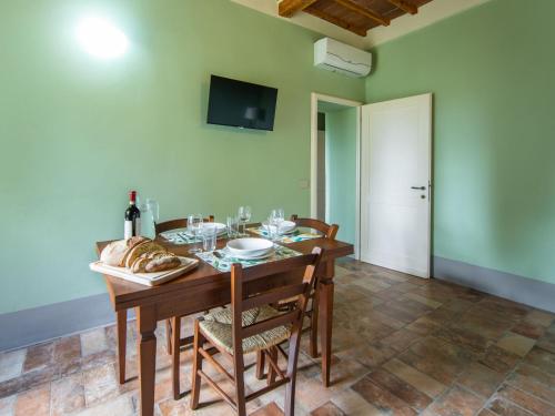 a dining room with a wooden table and chairs at Apartment Antico Duomo-4 by Interhome in Cortona