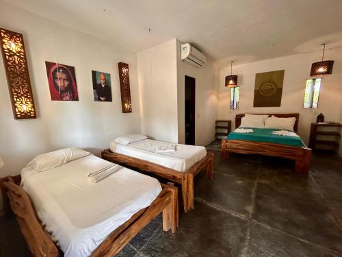 a room with two beds in a room at Pousada Maresia in Atins