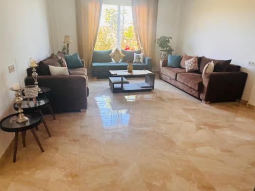 a living room with two couches and a table at Peaceful Pool Villa in Marrakech