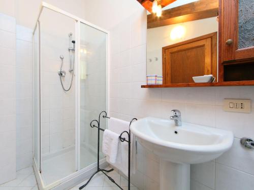 a white bathroom with a sink and a shower at Apartment Noemi by Interhome in Podere Panzano