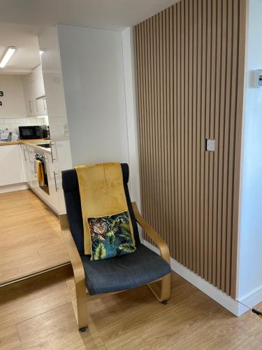 a chair with a pillow on it in a kitchen at The Garden Apartment in Newton Abbot