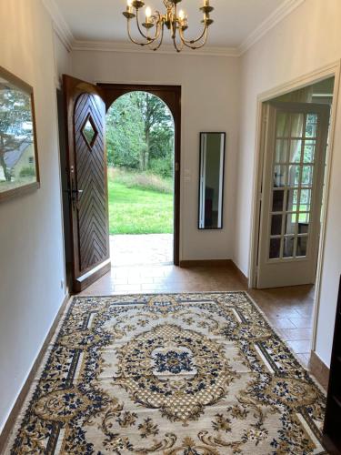 an entry way with a door and a rug at Cheerful two bedroom house PLONEVEZ du Faou in Plonévez-du-Faou