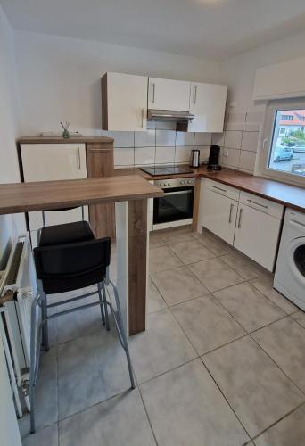 a kitchen with a wooden table and a counter top at MaxMir - Tannenweg Iserlohn, zentral - Parken - Küche - Netflix - Prime in Iserlohn