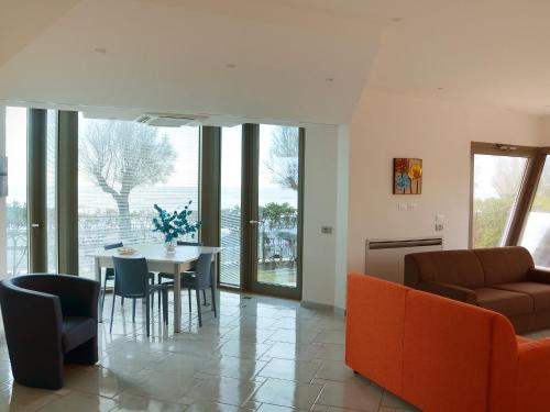 a living room with a couch and a table and chairs at Apartment Appartamento 1 by Interhome in Terracina