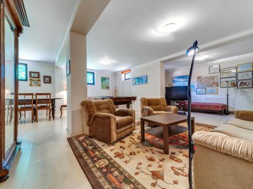 a living room with a couch and chairs and a table at Apartment Marcyporęba by Interhome in Marcyporęba