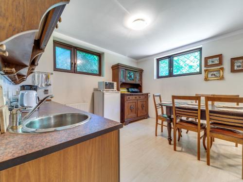 a kitchen with a sink and a dining room at Apartment Marcyporęba by Interhome in Marcyporęba