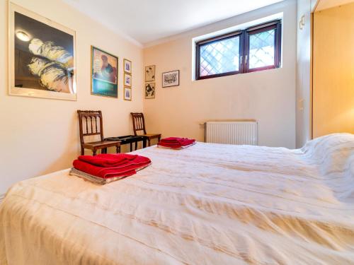 a large white bed in a bedroom with a window at Apartment Marcyporęba by Interhome in Marcyporęba
