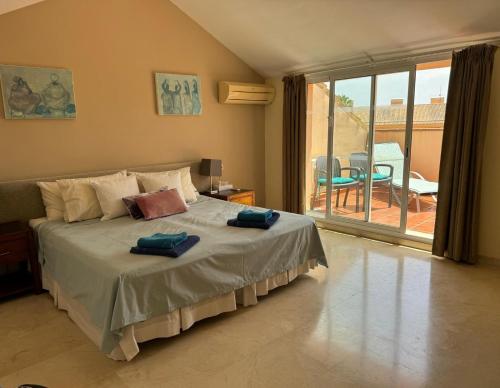 a bedroom with a bed with two towels on it at Luxury Duplex Penthouse in Marbella