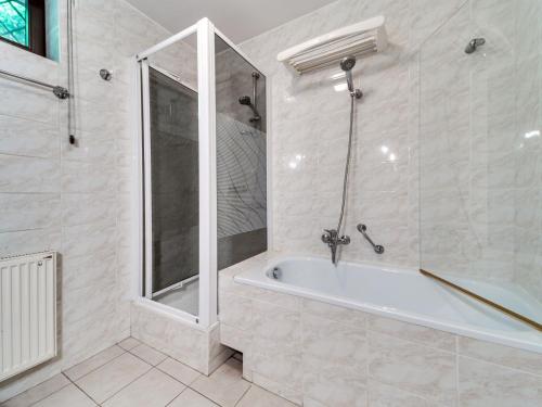a bathroom with a shower and a bath tub at Apartment Marcyporęba by Interhome in Marcyporęba