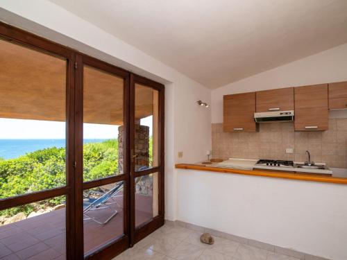 a kitchen with a view of the ocean at Holiday Home Mare-2 by Interhome in Li Valcaggi