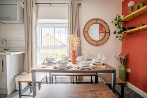a dining room with a table and a mirror at The Station Inn Apartment in Yeadon