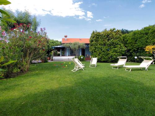 un patio con sillas de jardín y una casa en Villa Lavinia by Interhome, en Forte dei Marmi
