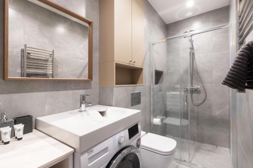 a bathroom with a sink and a toilet and a shower at StudioApart23 in Vilnius