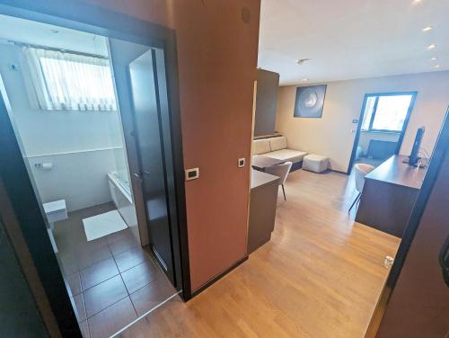 a room with a sliding door and a living room at Nitro Rooms in Ljubljana