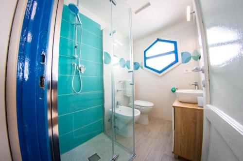 a bathroom with a shower and a toilet and a sink at Residence Eden in Comacchio