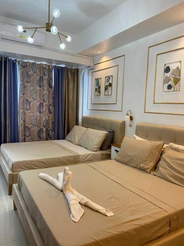 two beds with a stuffed animal laying on top of them at D Luckycharm staycation in Tagaytay