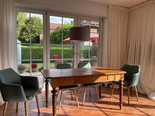 a dining room with a wooden table and chairs at Ferienhaus Jolufelu , Urlaub zwischen See und Golfplatz in Göhren-Lebbin