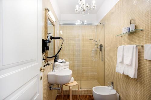 a bathroom with a sink and a shower at Hotel Palazzo Cavalieri in Siracusa