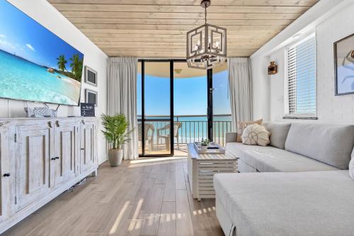 a living room with a couch and a view of the ocean at Remodeled Direct Ocean Front by Convention Center in Myrtle Beach