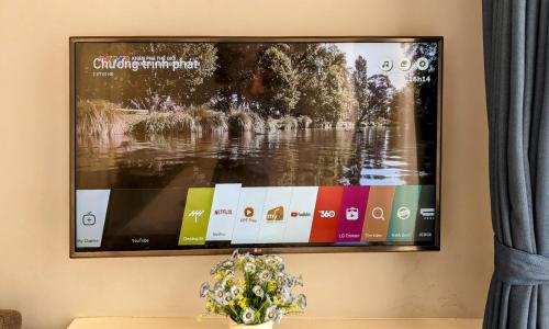 a flat screen tv hanging on a wall at Hanoi Home 2 - Lake View Apartment in Hanoi
