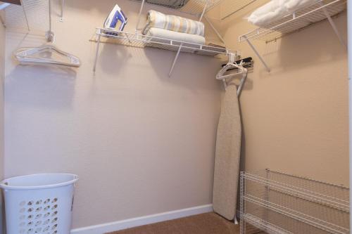 a walk in closet with a tie and towels at Gated Condo Heated Pool Putt Green Near Papago in Phoenix