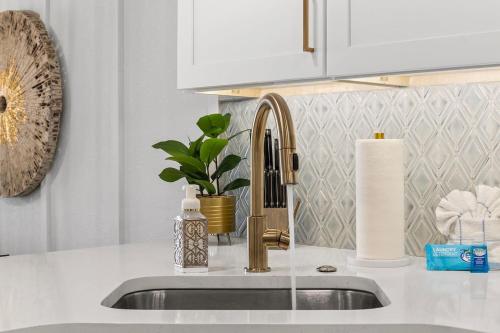 a kitchen sink with a faucet and a counter top at Luxury Ocean Front By Barefoot Landing in Myrtle Beach