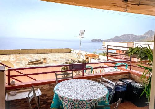 a balcony with a table and a view of the ocean at Bellavista apartment Letojanni in Letojanni