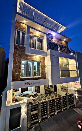 a building with a car parked in front of it at Ruby Villa in Puducherry