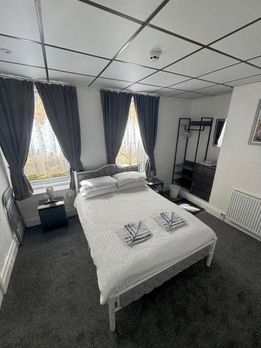 a bedroom with a bed with two towels on it at The Mornington Hotel in Blackpool