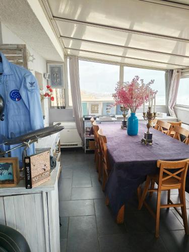 une salle à manger avec une table et des chaises et une fenêtre dans l'établissement Duplex Exceptionnel Vue Mer, à Canet