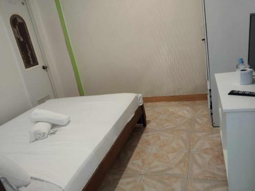 a small room with a bed and a desk at Harbour Chateau in Odiongan