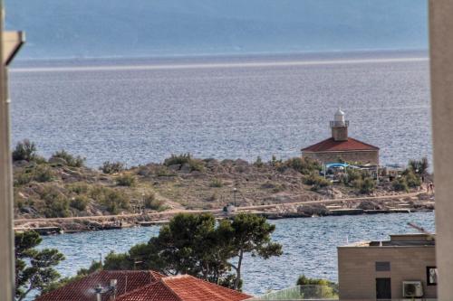 a lighthouse on an island in the water at Villa Melassy in Makarska