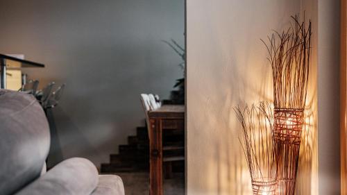 a vase with grass in it next to a table at Casa Della Luce Apartments by Zermatt Premium Apartments in Zermatt