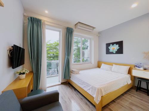 sypialnia z łóżkiem i oknem w obiekcie Hanoi Home 2 - Lake View Apartment w mieście Hanoi