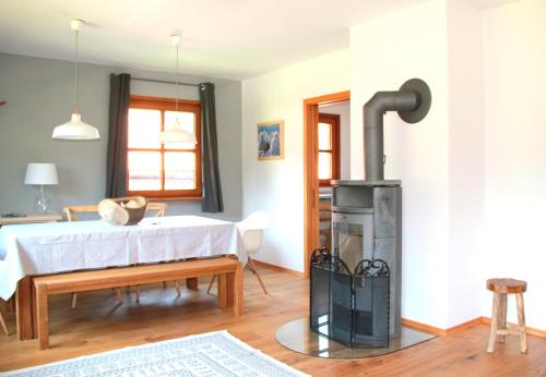 a living room with a wood burning stove in it at Ferienwohnung Oberammergau in Oberammergau