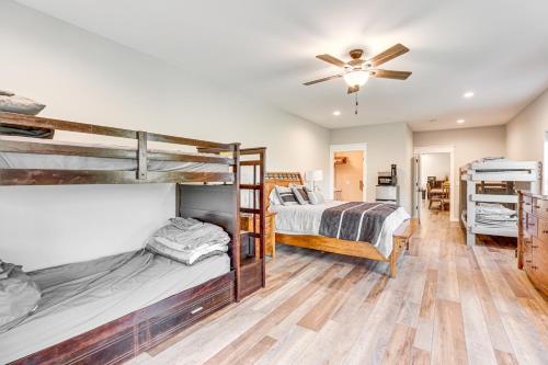 a bedroom with two bunk beds and a ceiling fan at Sprawling Wisconsin Dells Home with Deck and Fire Pit in Wisconsin Dells