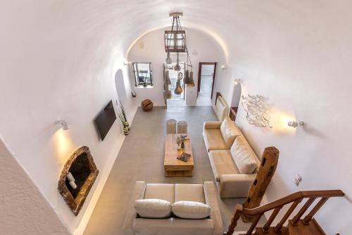 a living room with a couch and a table at 180° Caldera by Stylish Stays in Firostefani