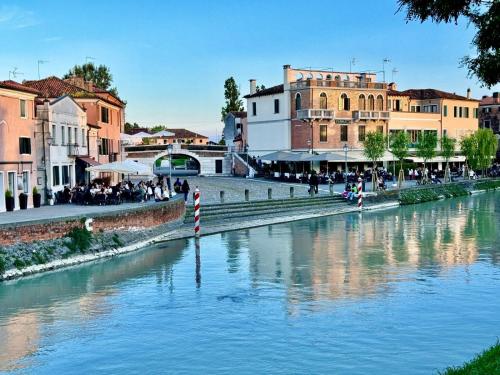 a view of a river in a city with buildings at ERMAN HOUSE Mansarda sulla Riviera del Brenta Venezia in Dolo