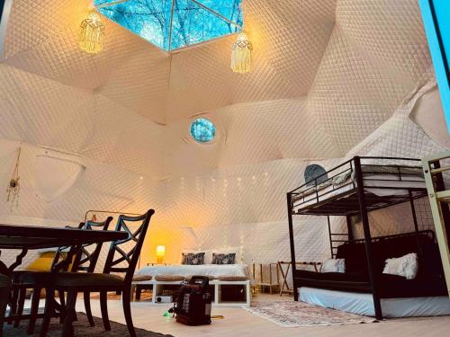 a room with two bunk beds in a tent at The Perch Glamping By Rafting in Cosby