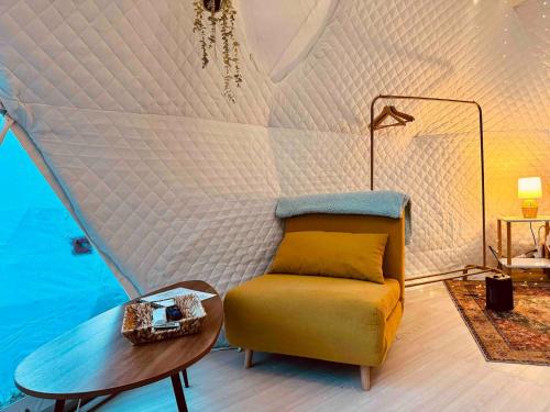 a living room with a couch and a table at The Perch Glamping By Rafting in Cosby