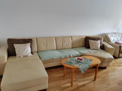 a living room with a couch and a table at Apartman SM in Sremska Mitrovica