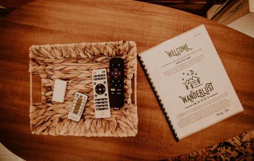 a book and a remote control in a box on a table at The Perch Glamping By Rafting in Cosby