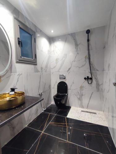 a bathroom with a toilet and a sink at La Cascade Ḩammām al Ghazzāz in Kelibia