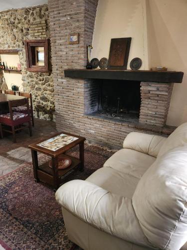 a living room with a couch and a fireplace at Casa a Scale in Sulmona