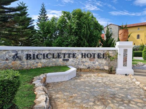 a sign for abiographical hotel on a stone wall at Biciclette hotel khaoyai in Ban Bung Toei